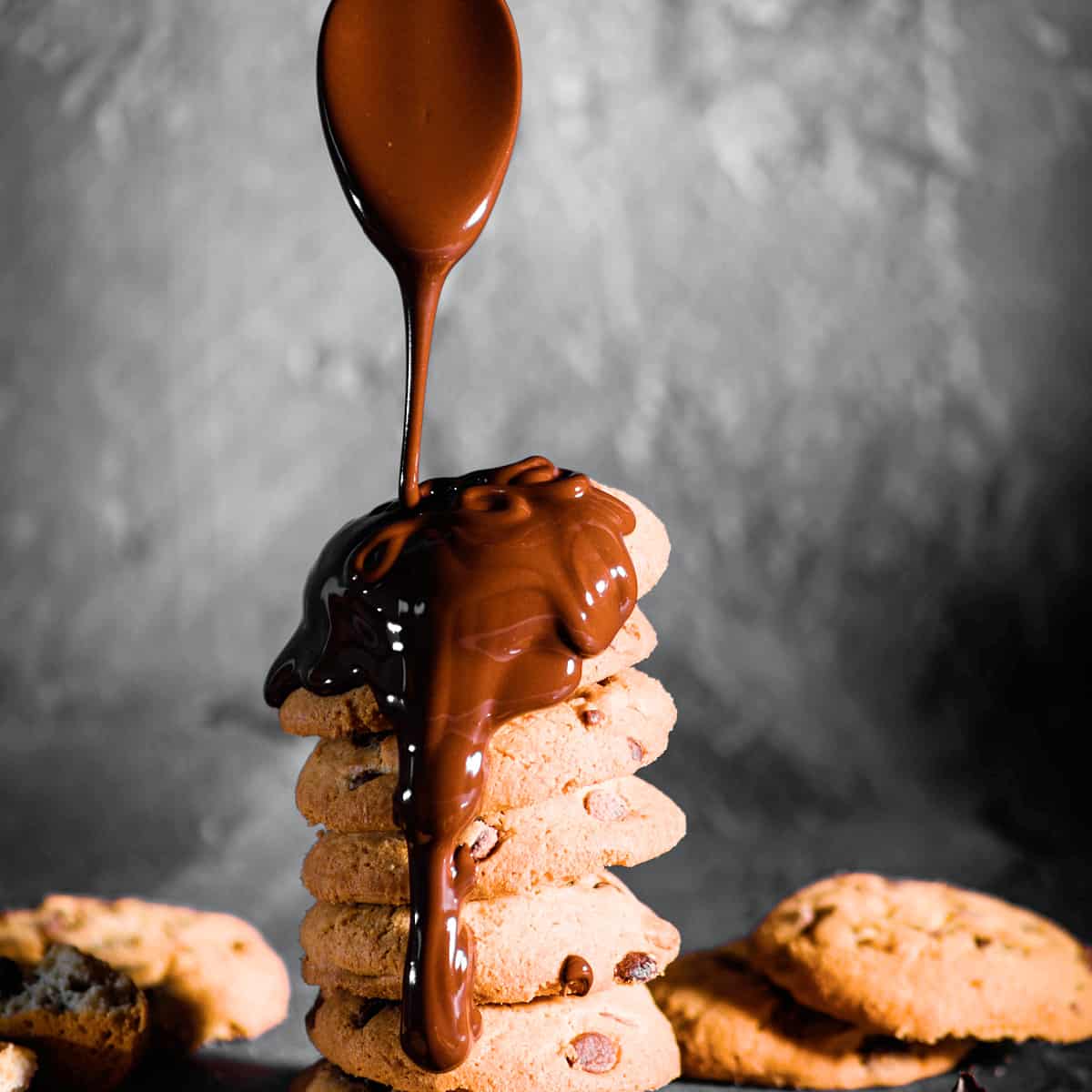 melted chocolate dripping over cookies.