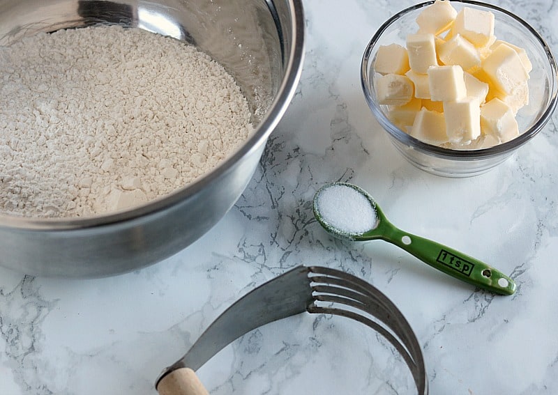 cubes of butter with flour on counter. 