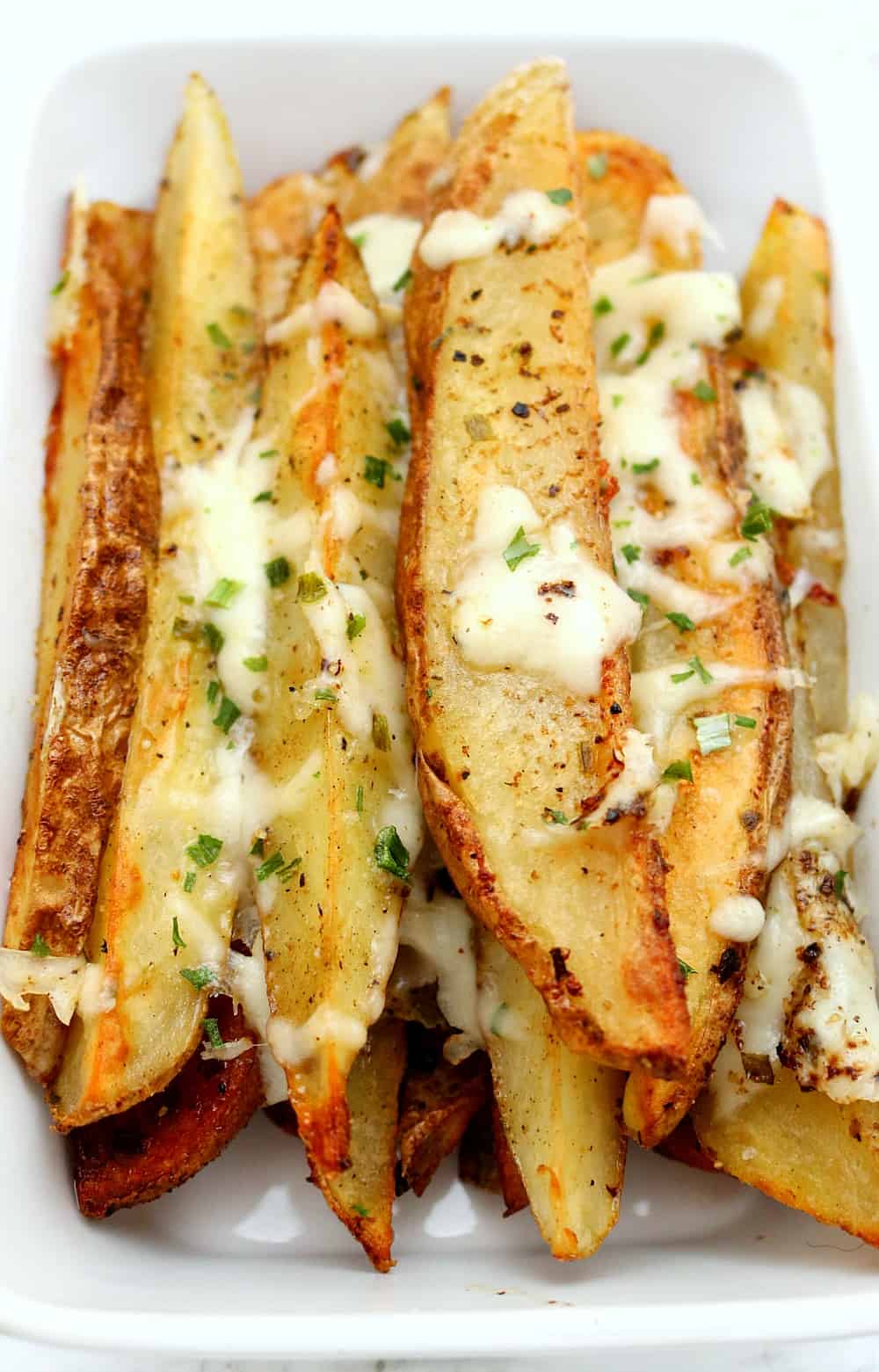 seasoned potato wedges in dish. 