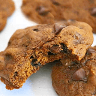 pumpkin chocolate chip cookies with bite missing.