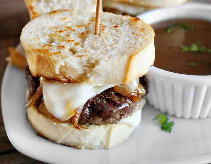 french onion soup recipe beef slider on white plate with ramekin of au jus