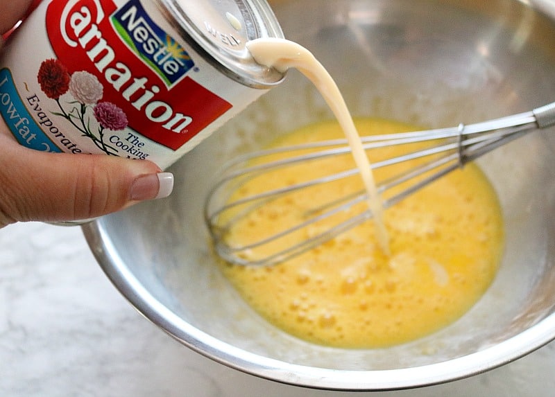 evaporated milk pouring into bowl.