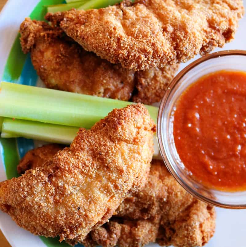 crunchy fried keto chicken tenders on a plate with celery.