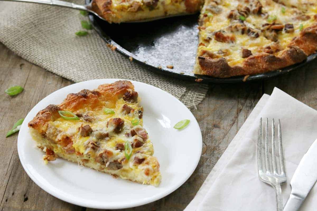 a slice of pizza on cutting board.