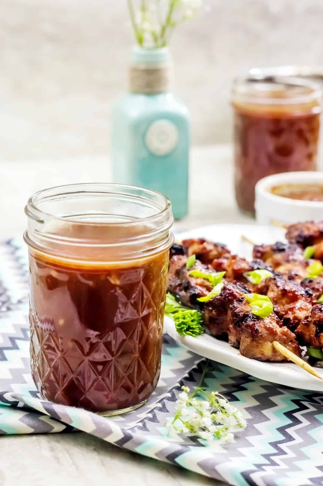 a mason jar full of sugar free BBQ sauce on a decorated table. 