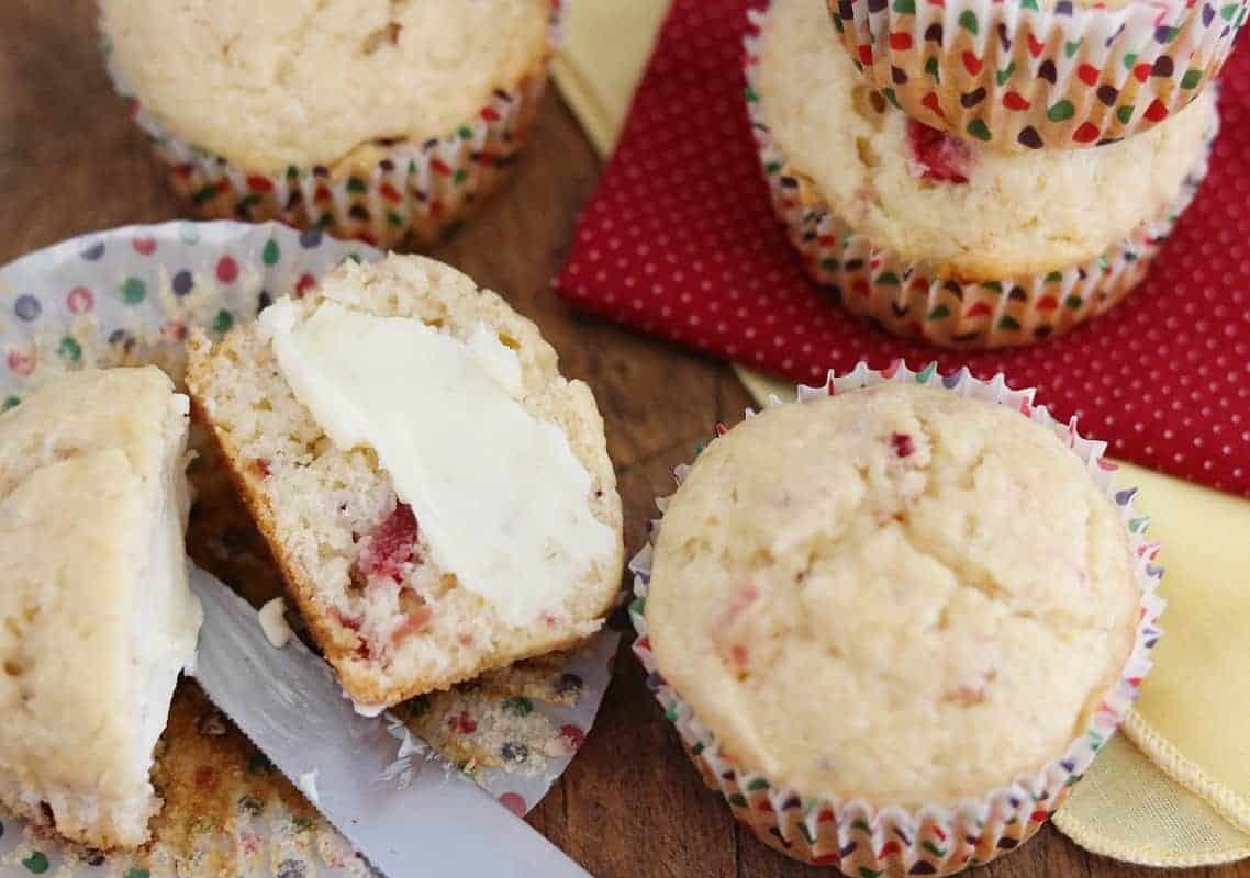 low carb cranberry orange muffins with butter and knife on plate.