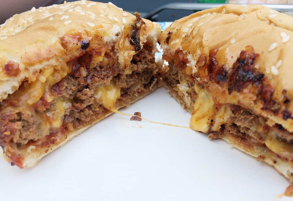 Turkey sloppy joes burgers are cut in half with cheese