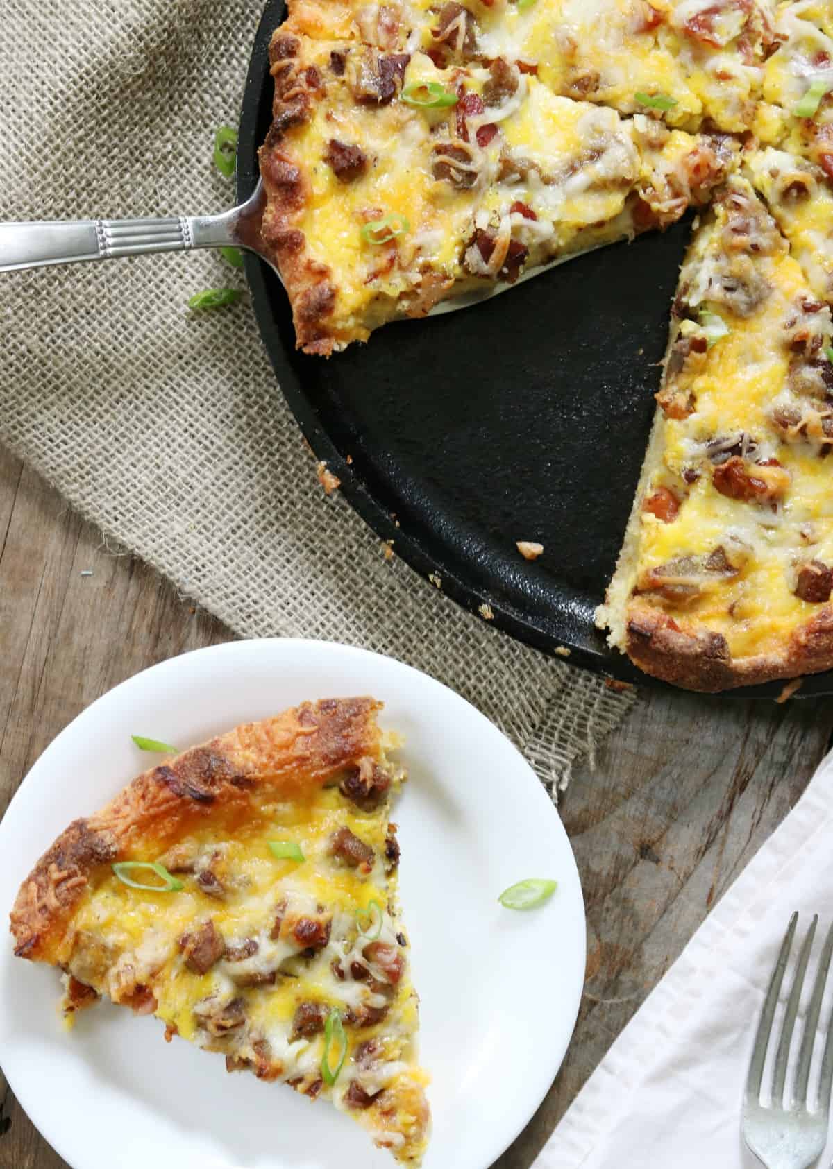 keto breakfast pizza slice on white plate.