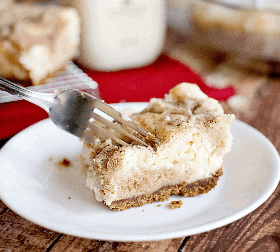 keto snickerdoodle cheesecake bars with fork on plate.