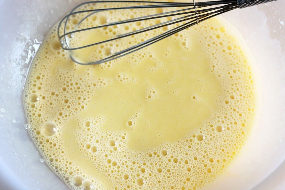 eggs in bowl being whisked.