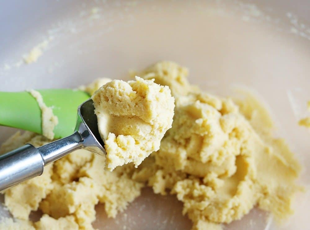 dough scoop held over a bowl.