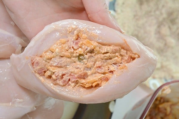 chicken breast being stuff with cheese.