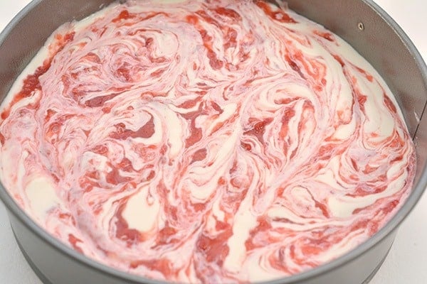 swirled strawberry keto cheesecake in pan 