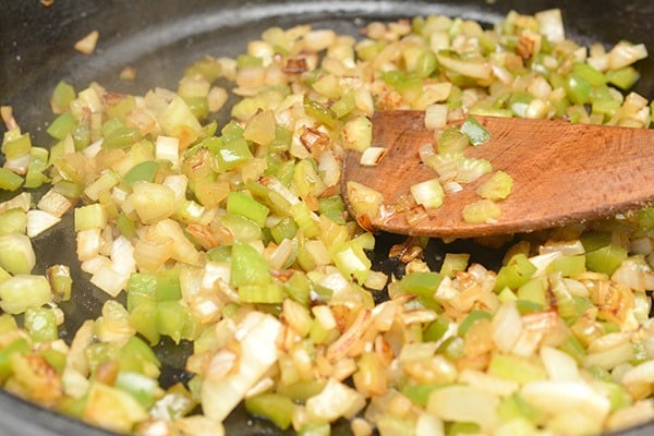 vegetables diced and sauteing on stove 