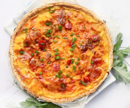 bacon cheddar quiche on table 
