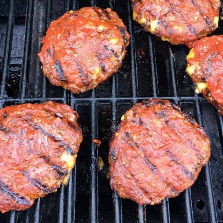 sloppy joe sauce covered burgers on the grill.