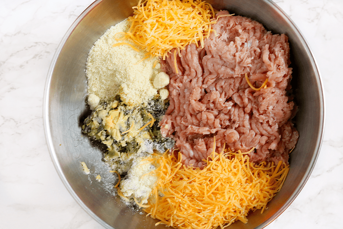ground chicken and cheese in bowl. 