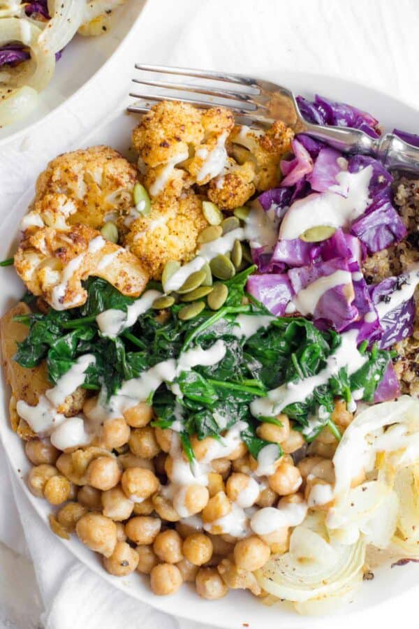 cauliflower with greens and chick peas in a bowl.
