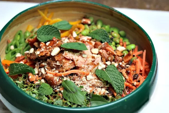 thai salmon in bowl with salad. 