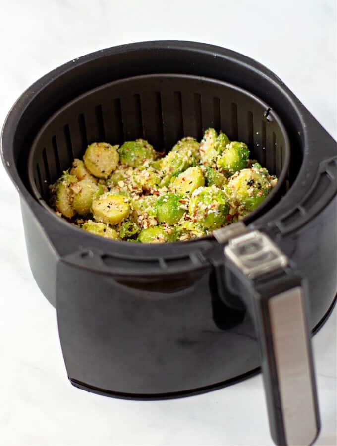 frozen seasoned brussel sprouts in air fryer basket. 