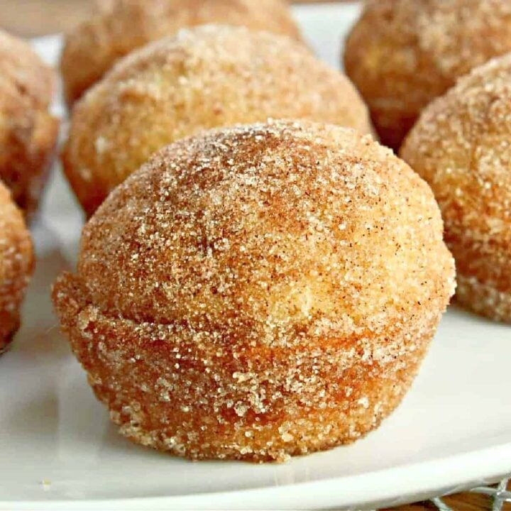 a baked keto cinnamon sugar donut muffin on a plate.