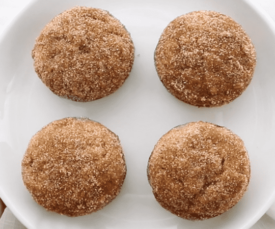 keto muffins rolled in cinnamon sugar on plate.