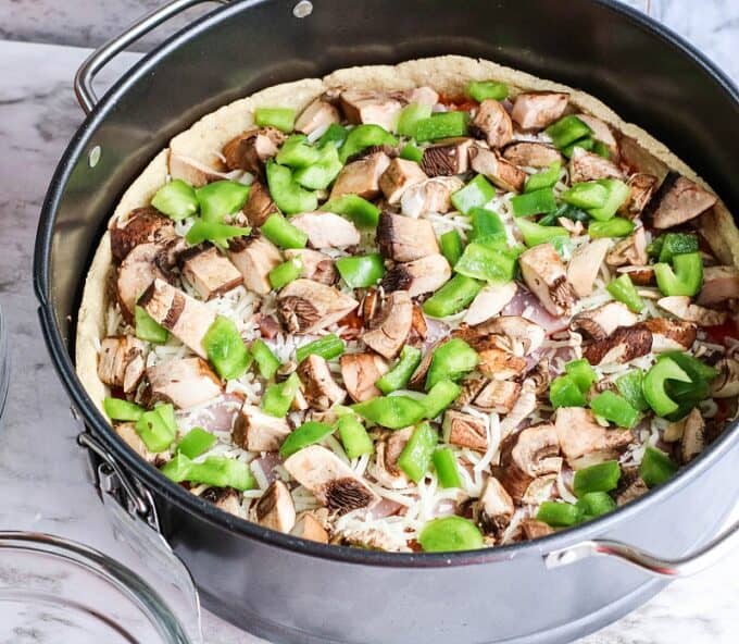 mushrooms and peppers on pizza dough.