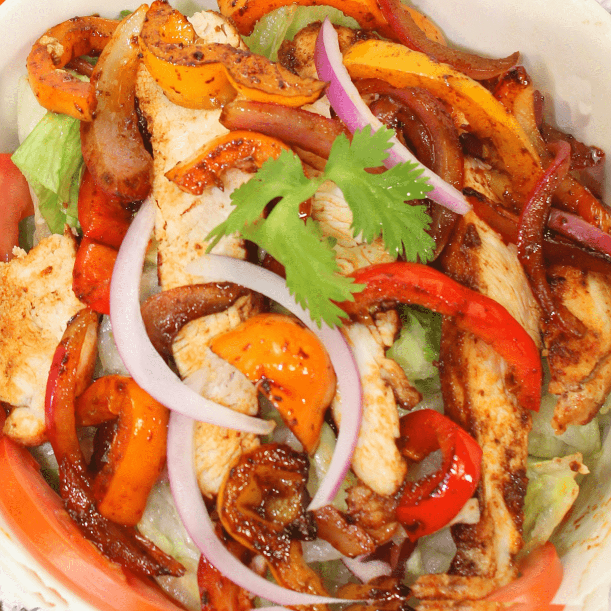 chicken with peppers and onions in fajita bowl.