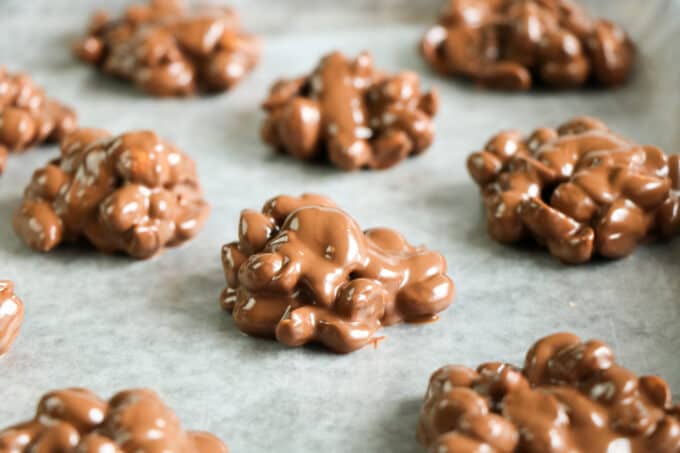 easy low carb chocolate candy with peanuts on a cookie sheet not set up yet.