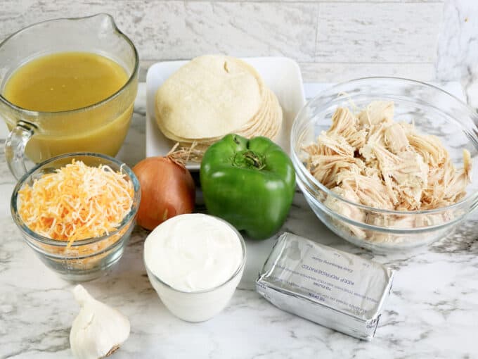 chicken enchiladas with cream cheese ingredients on counter. 