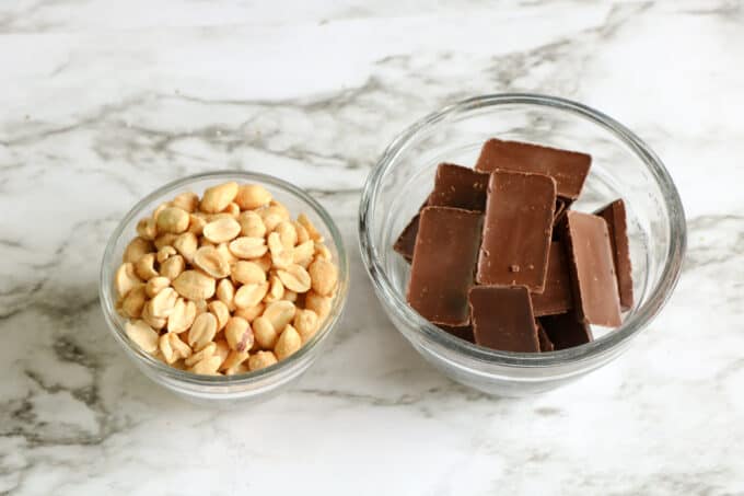 chocolate bars and peanuts in separate bowls. 