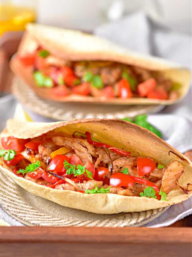 air fryer chicken fajitas are chicken and peppers in tortilla. 