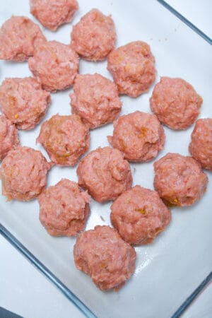 Thai meatballs uncooked on a pan. 
