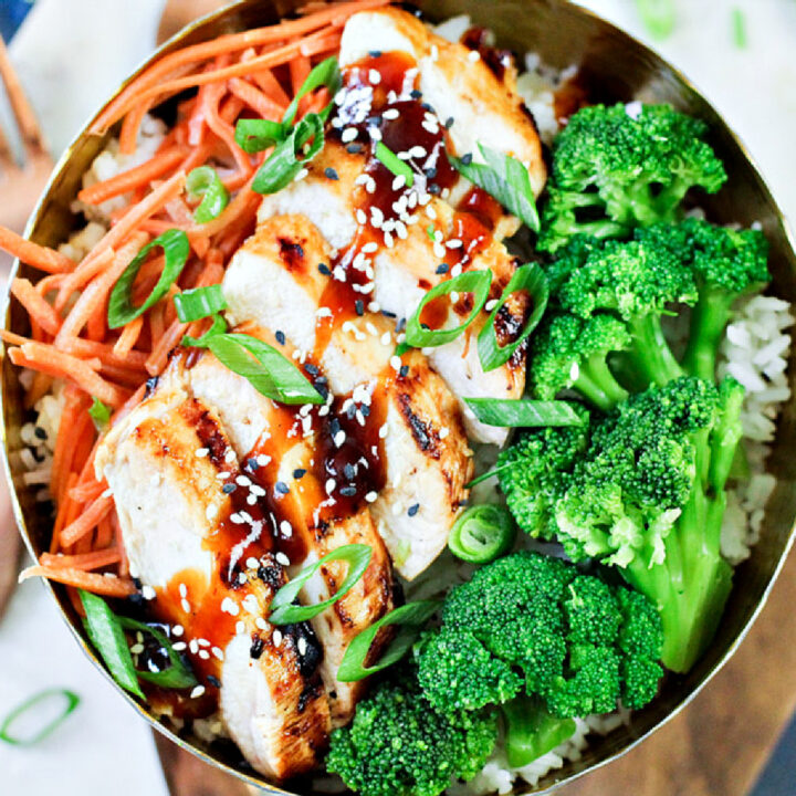 grilled chicken with general tso's sauce on it in a bowl of broccoli .