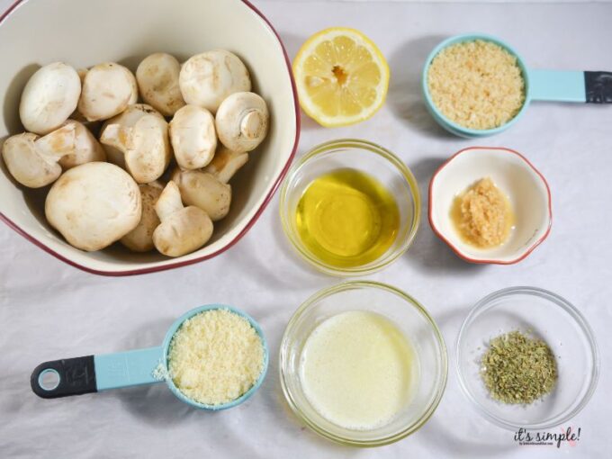 Ingredients for garlic parmesan mushrooms including mushrooms, garlic, butter, and parmesan