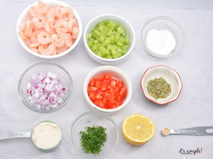 Prepped ingredients for low carb shrimp salad with chopped vegetables and seasonings