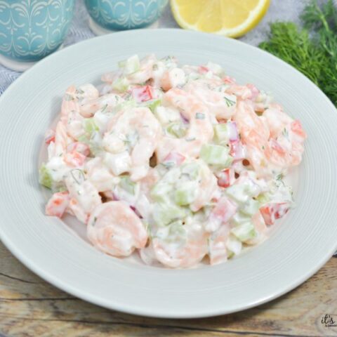 Creamy keto shrimp salad with fresh dill and crunchy vegetables in a white bowl